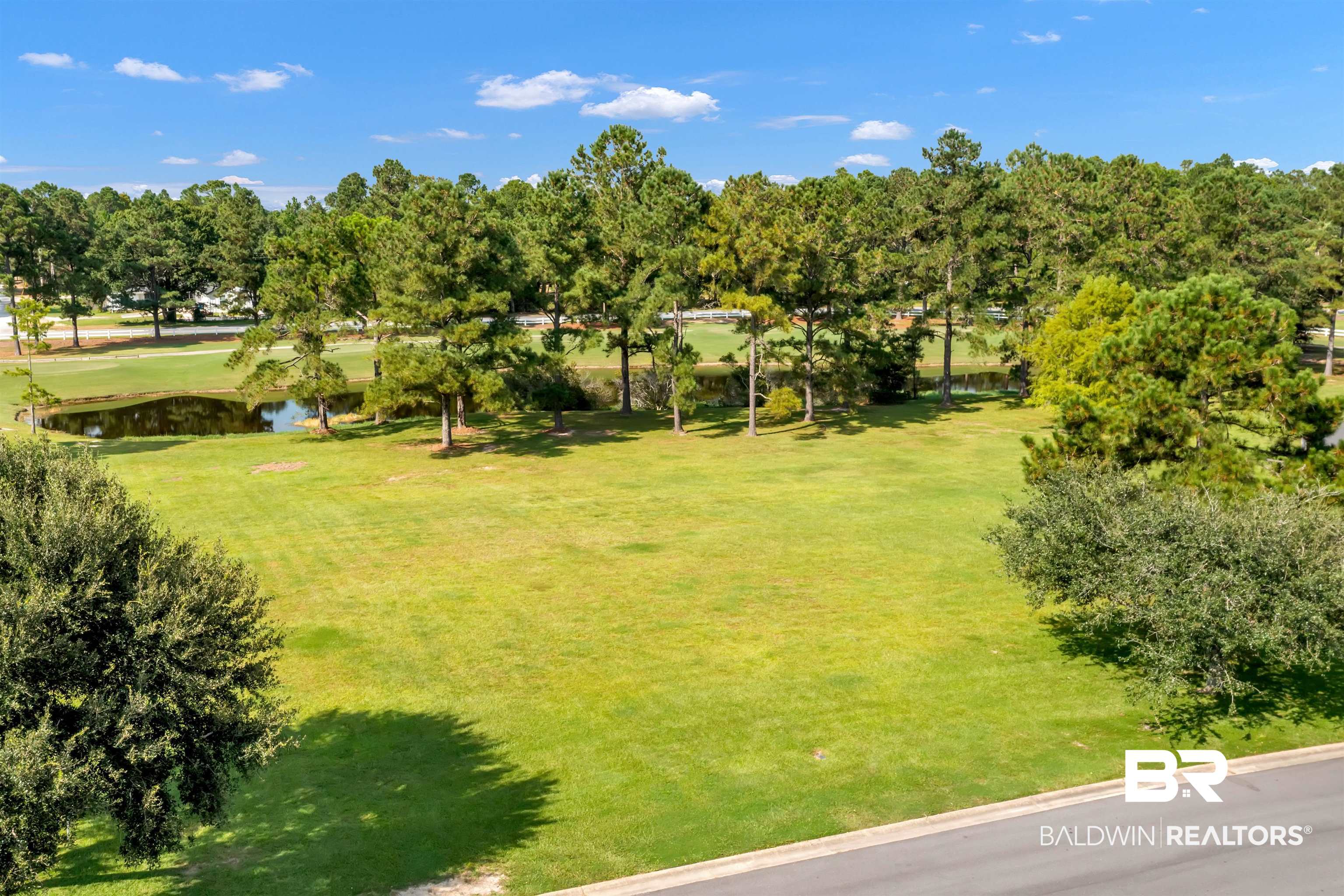 Lakes Circle Gulf Shores, AL 36542 - Photo 2 of 15 Bird's eye view of a tree filled landscape and a large body of water