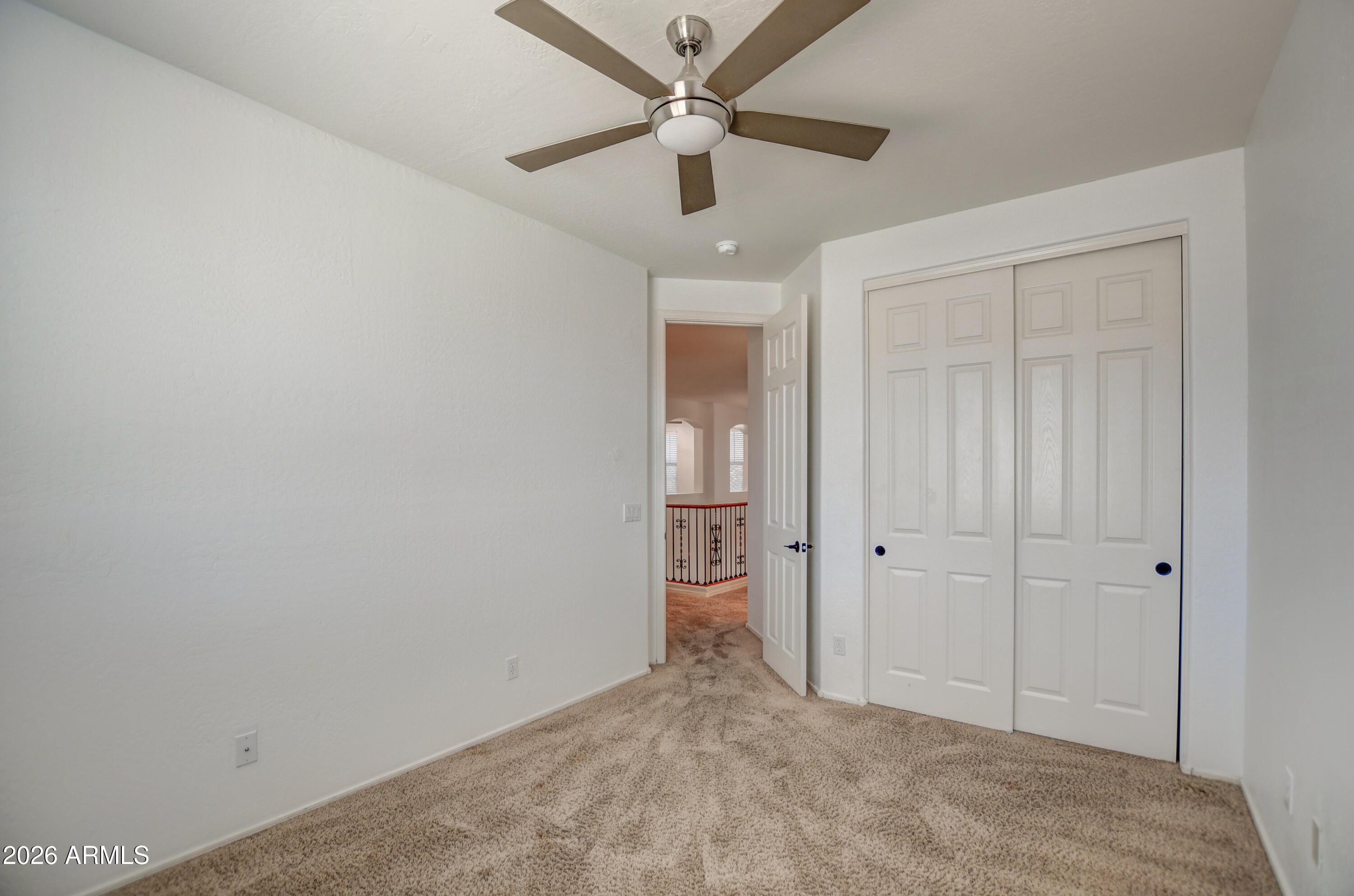 3078 East Muirfield Street Gilbert, AZ 85298 - Photo 70 of 92 an empty room with closet and a ceiling fan