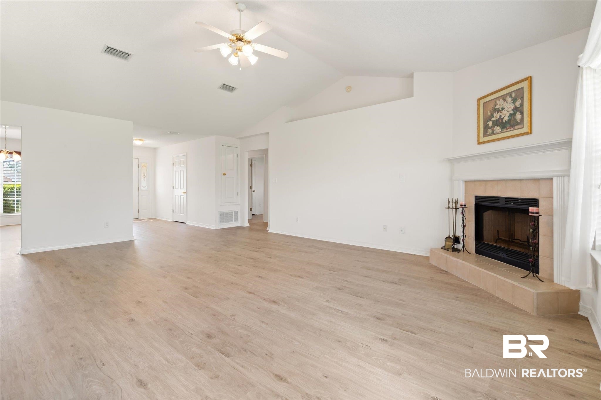 12520 Hunters Chase Foley, AL 36535 - Photo 18 of 32 Unfurnished living room featuring ceiling fan, light wood-style flooring, visible vents, and a tile fireplace