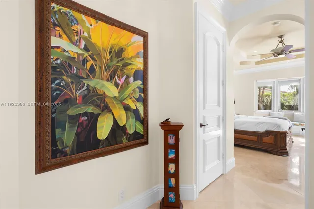 a bedroom with a bed mirror and a window