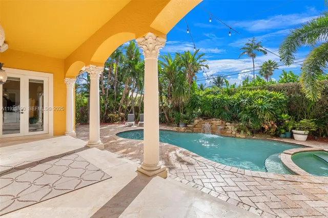 a view of a porch with a floor to ceiling window and yard