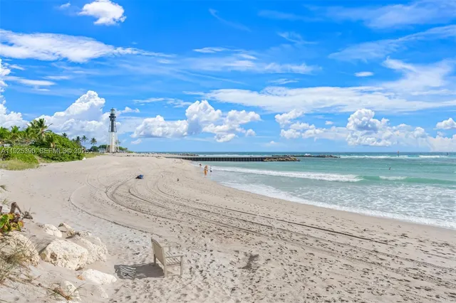 an aerial view of a houses with a yard