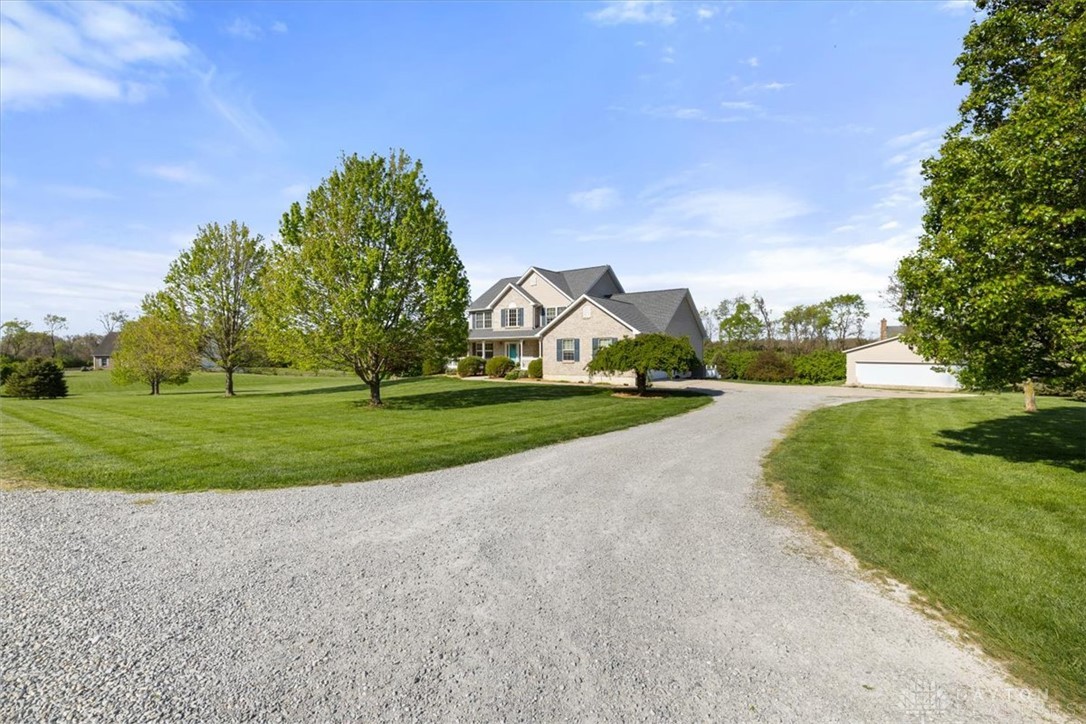 841 Willow Road Springfield, OH 45502 - Photo 62 of 64 This expansive estate features a graceful gravel driveway leading to a classic residence and detached garage.