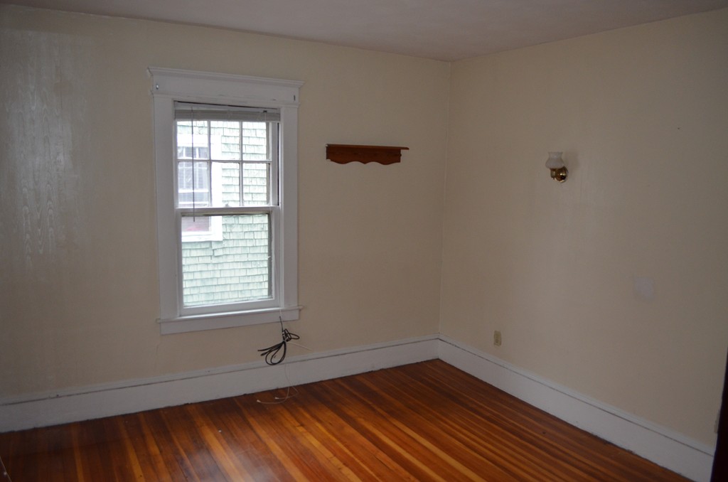 32 Ardmore Street Springfield, MA 01104 - Photo 11 of 17 an empty room with wooden floor and windows