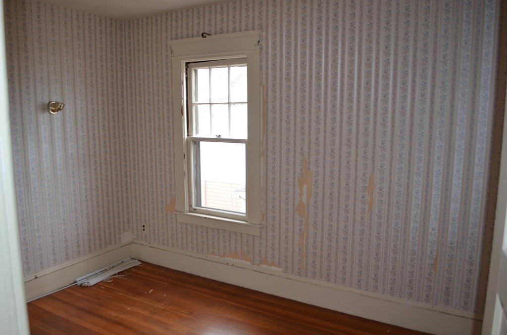 32 Ardmore Street Springfield, MA 01104 - Photo 13 of 17 a view of an empty room with wooden floor and a window