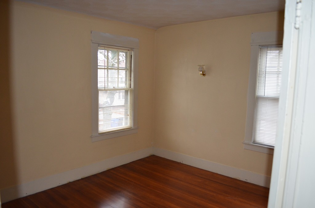 32 Ardmore Street Springfield, MA 01104 - Photo 14 of 17 a view of an empty room with wooden floor and a window