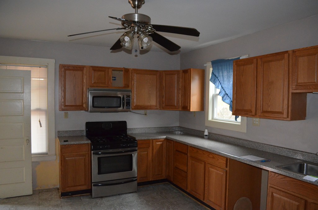 32 Ardmore Street Springfield, MA 01104 - Photo 5 of 17 a kitchen with stainless steel appliances a stove sink microwave and cabinets