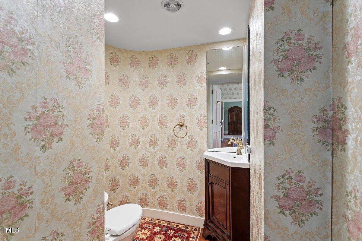 206 Shaver Road Macon, NC 27551 - Photo 42 of 68 a bathroom with a sink a toilet and shower curtain