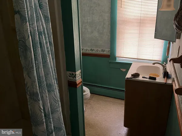 a bathroom with a sink a toilet and a window