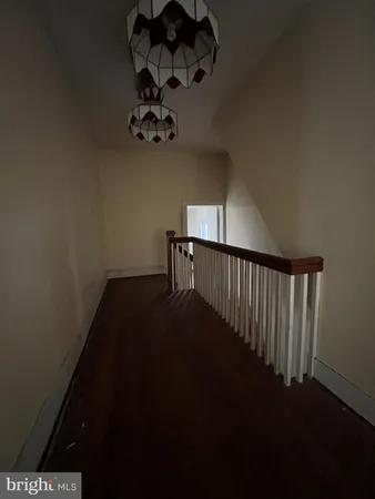 a view of a hallway with a flower pot on the table