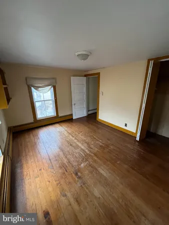 an empty room with windows and closet