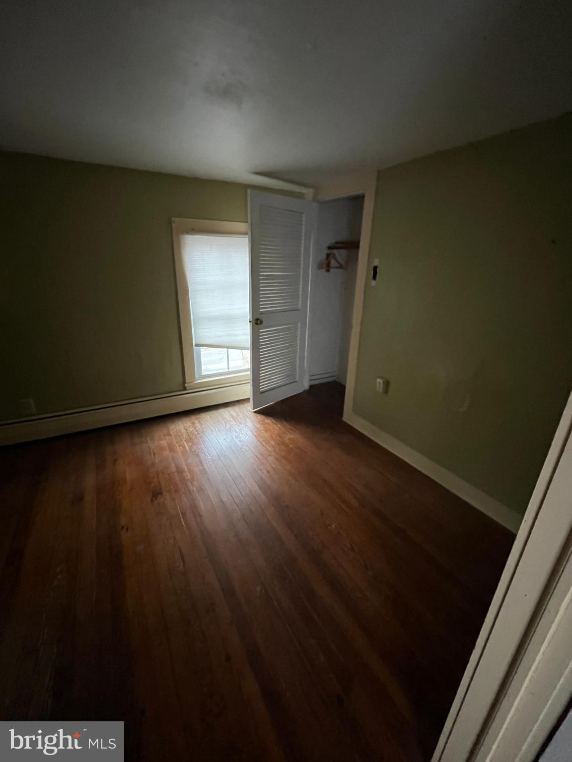 10603 Bishopville Road Bishopville, MD 21813 - Photo 21 of 28 a view of an empty room with wooden floor and a window