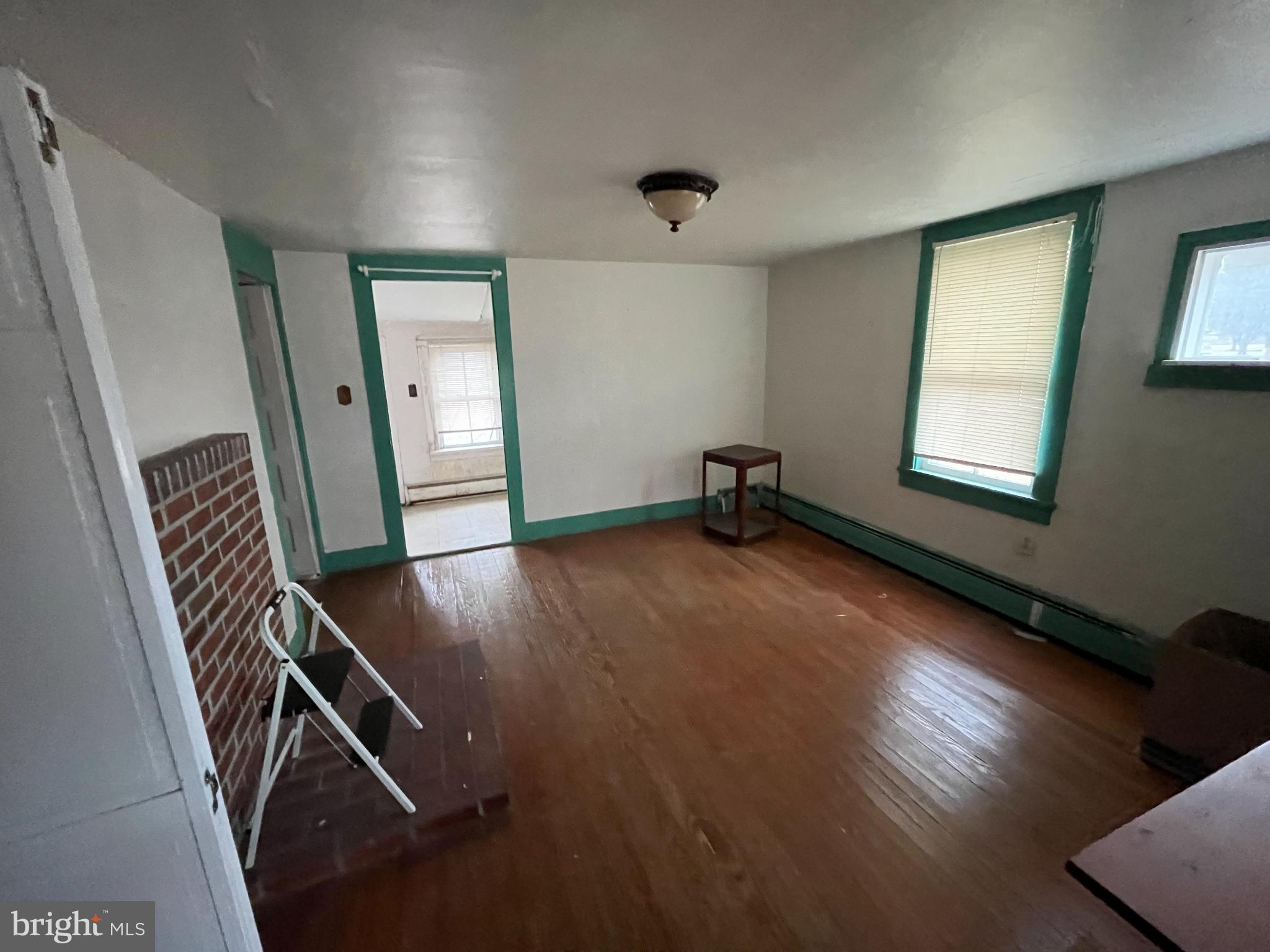 10603 Bishopville Road Bishopville, MD 21813 - Photo 24 of 28 a view of an empty room with wooden floor and a window