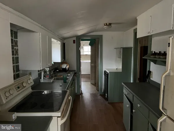 a kitchen with a sink stove and refrigerator