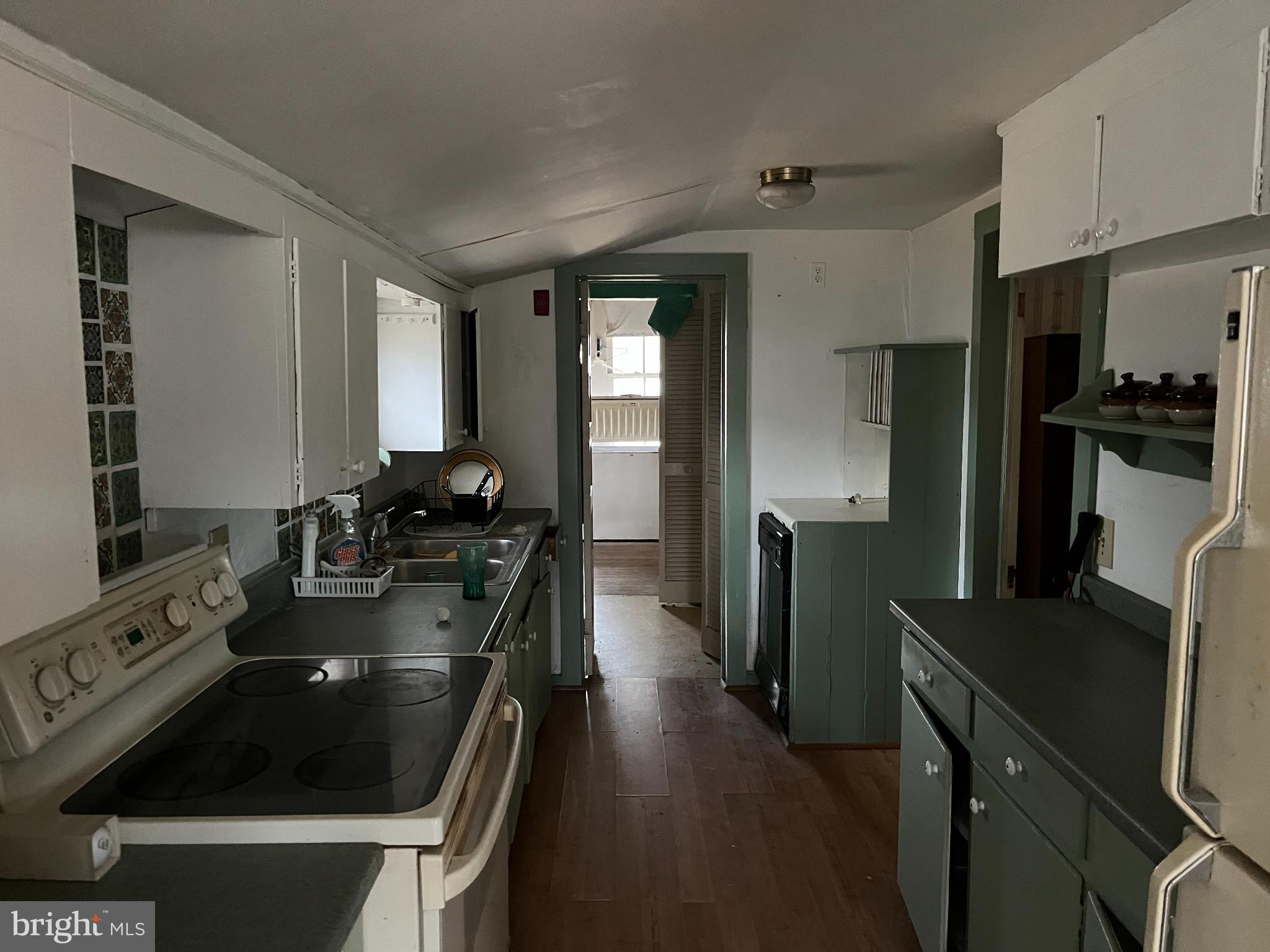 10603 Bishopville Road Bishopville, MD 21813 - Photo 8 of 28 a kitchen with a sink stove and refrigerator