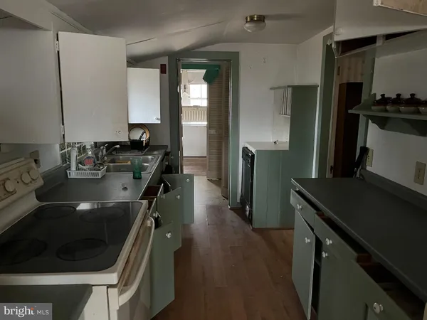 a kitchen with a sink stove and refrigerator
