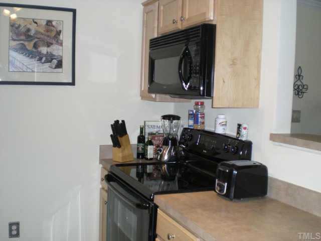 2304 Myron Drive, Unit 201 Raleigh, NC 27607 - Photo 6 of 12 a kitchen with a sink and a stove top oven with wooden floor