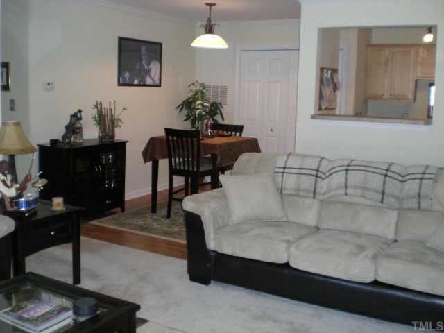 2304 Myron Drive, Unit 201 Raleigh, NC 27607 - Photo 7 of 12 a living room with furniture and a dining table