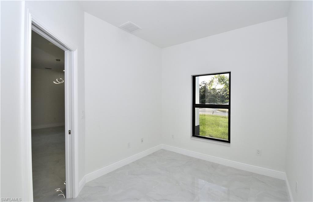 349 Naples Avenue South Lehigh Acres, FL 33974 - Photo 11 of 22 an empty room with windows and closet