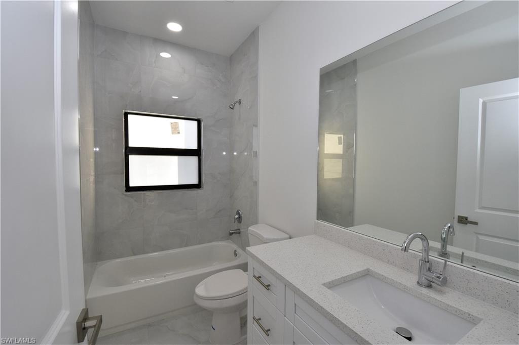 349 Naples Avenue South Lehigh Acres, FL 33974 - Photo 18 of 22 a bathroom with a sink toilet tub and shower