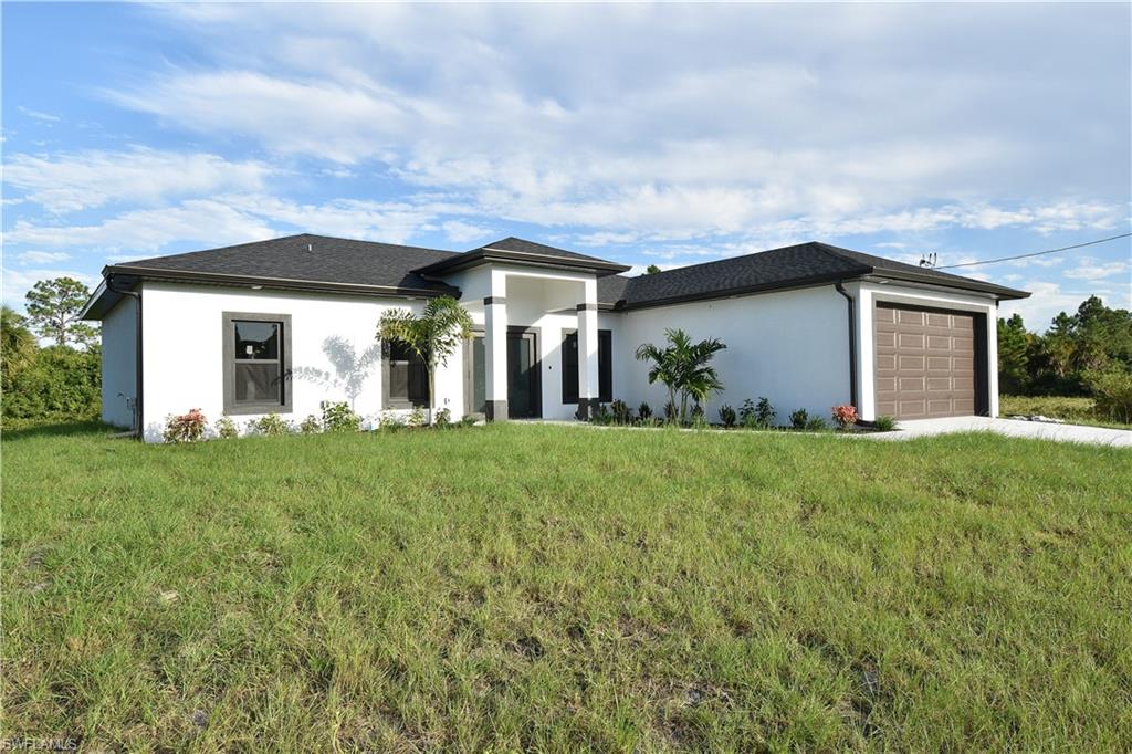349 Naples Avenue South Lehigh Acres, FL 33974 - Photo 2 of 22 front view of house with a yard