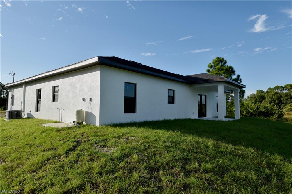 349 Naples Avenue South Lehigh Acres, FL 33974 - Photo 4 of 22 a house with garden in front of it