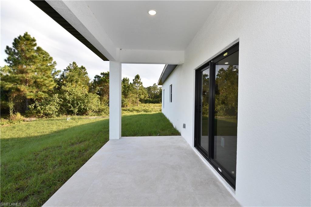 349 Naples Avenue South Lehigh Acres, FL 33974 - Photo 5 of 22 a view of a porch and garden