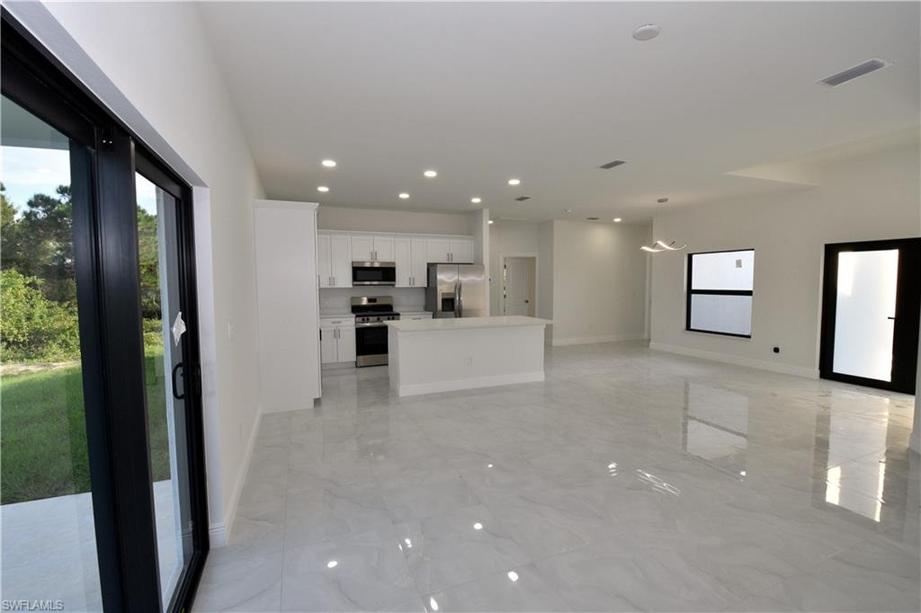 349 Naples Avenue South Lehigh Acres, FL 33974 - Photo 7 of 22 a view of a living room a window and a kitchen