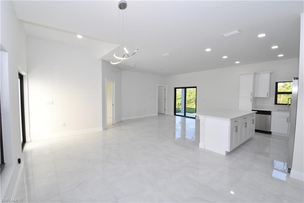 349 Naples Avenue South Lehigh Acres, FL 33974 - Photo 8 of 22 an empty room with windows and cabinet