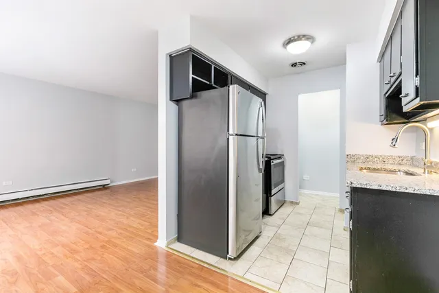 a kitchen with stainless steel appliances granite countertop a refrigerator and a sink