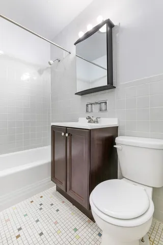a bathroom with a toilet a sink and bathtub