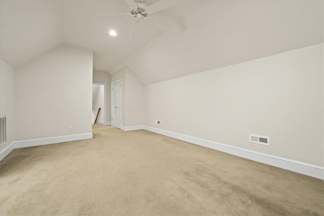 38 Angus Run Seneca, SC 29672 - Photo 35 of 46 This spacious room features vaulted ceilings and plush carpet, creating an inviting and comfortable atmosphere.