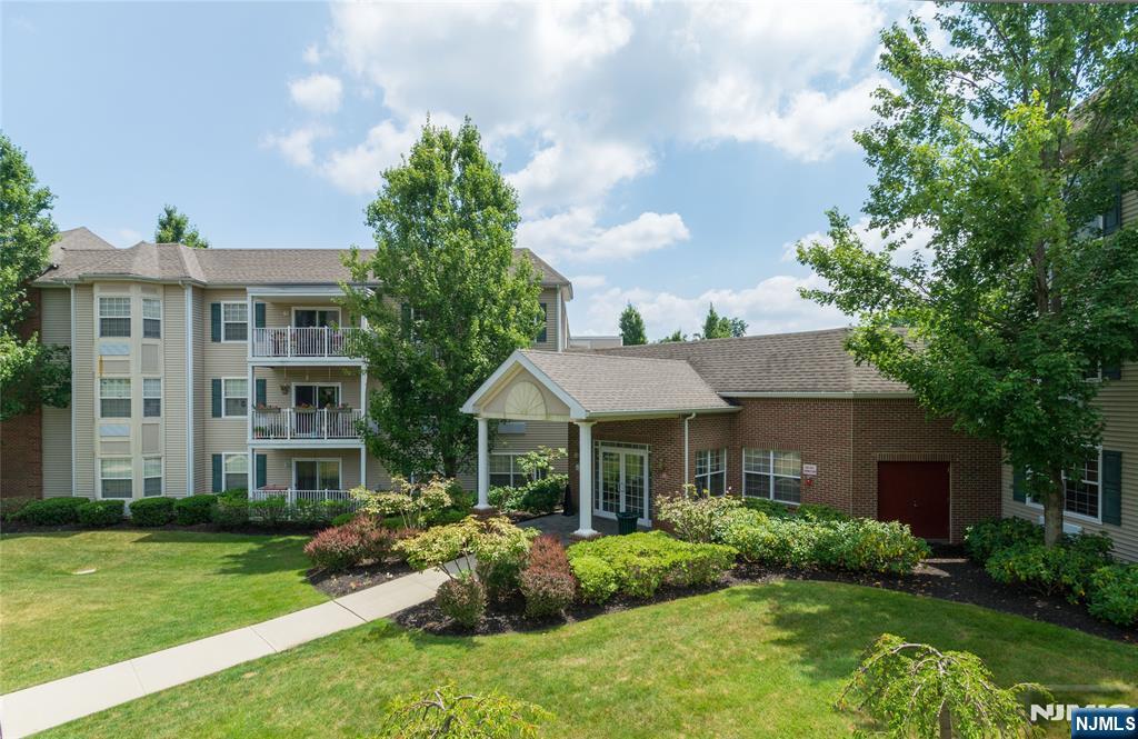 a front view of a house with porch and garden