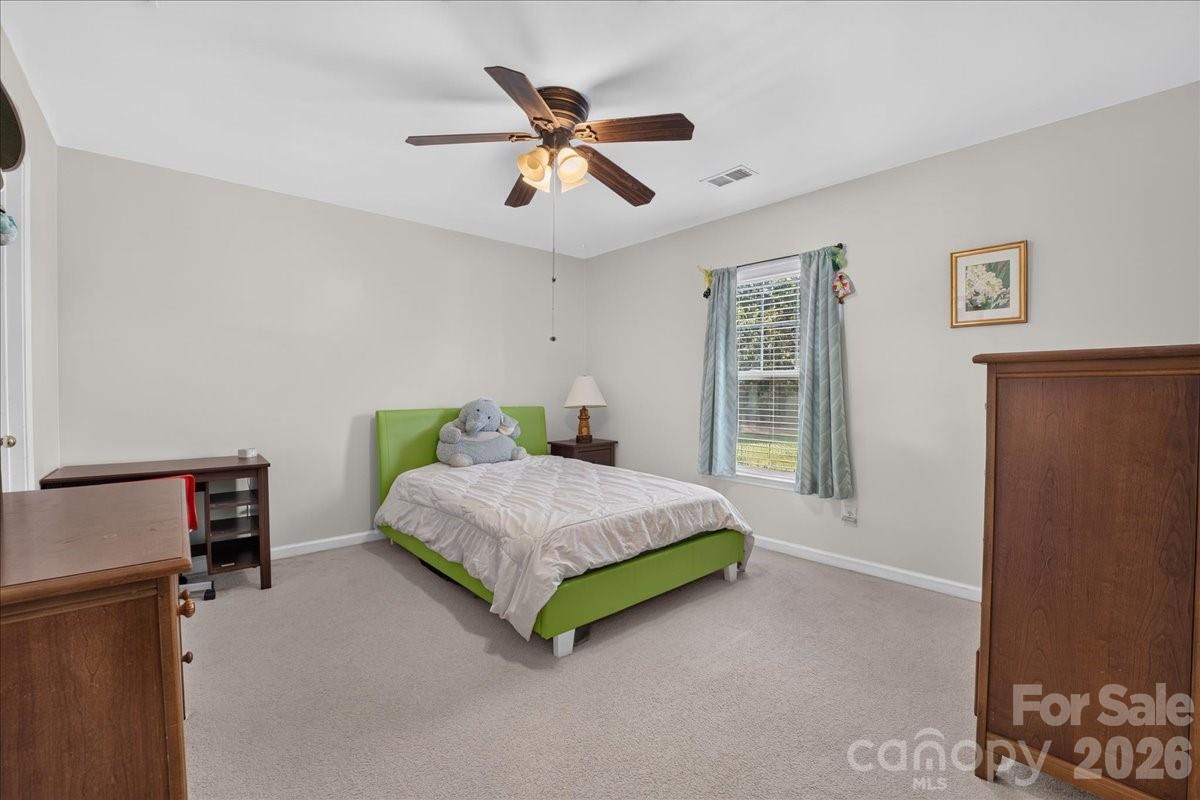 8006 Fine Robe Drive Indian Trail, NC 28079 - Photo 22 of 36 a bedroom with a bed and a ceiling fan