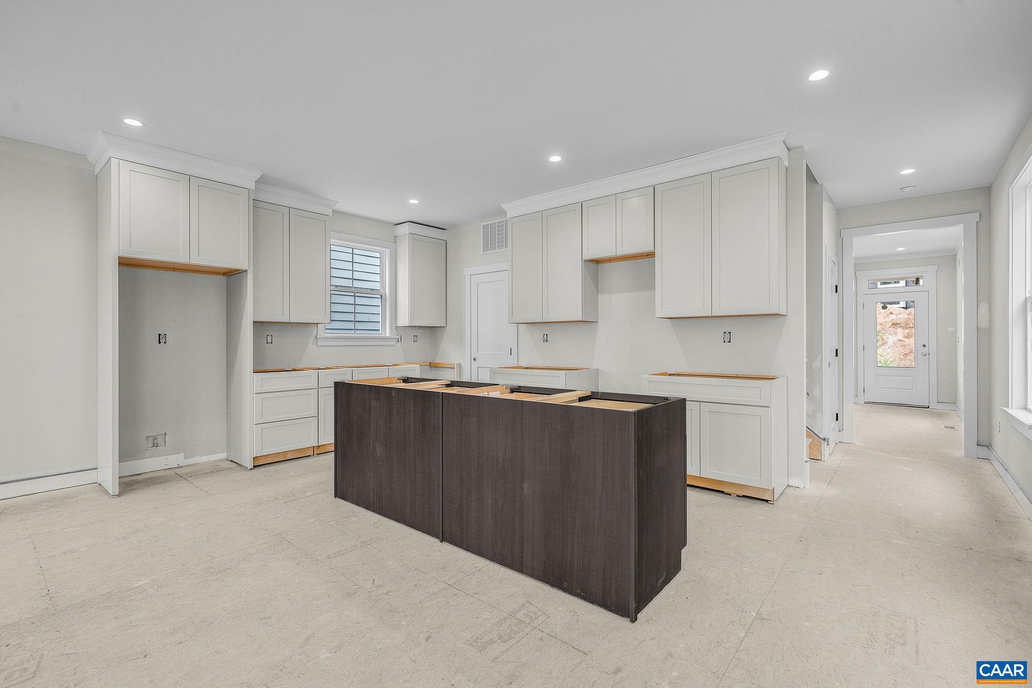 444 Nicholson Street Charlottesville, VA 22901 - Photo 8 of 26 a large kitchen with cabinets and a refrigerator