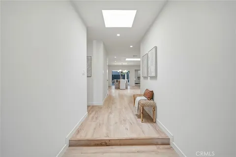 a kitchen with a table chairs sink and cabinets