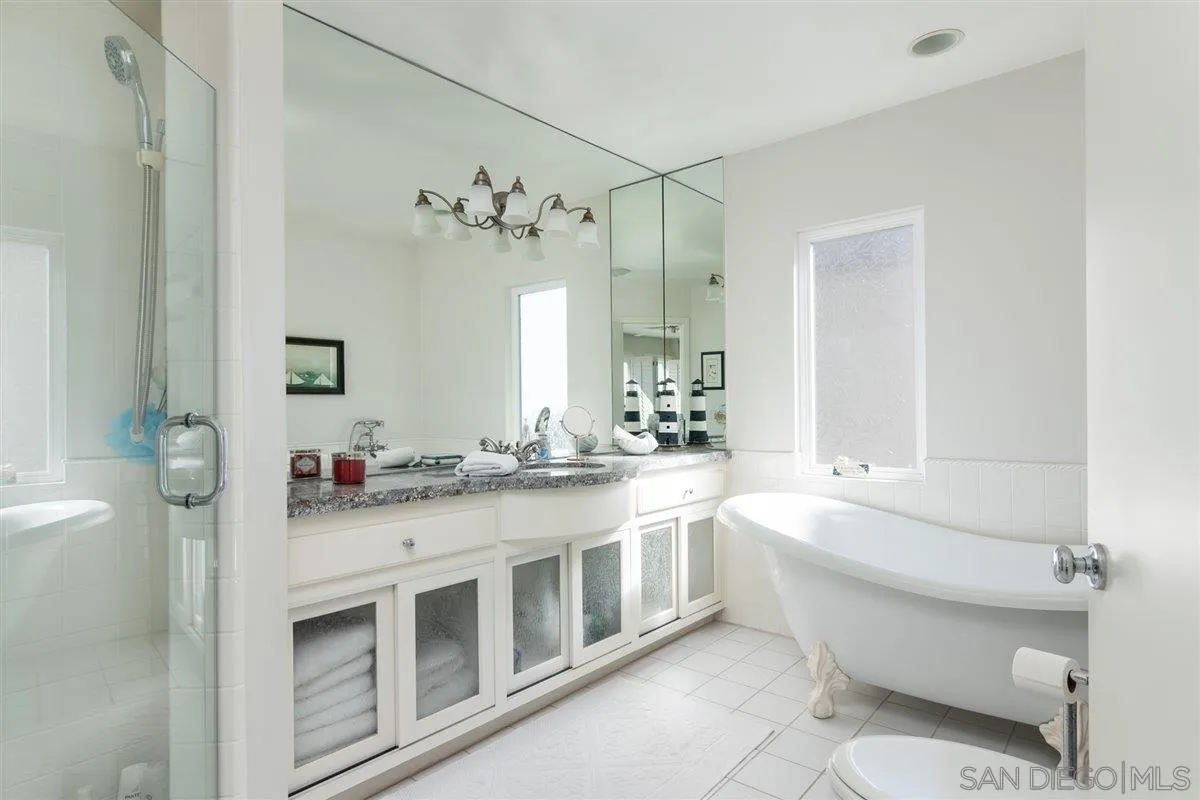 48 Half Moon Bend Coronado, CA 92118 - Photo 31 of 41 a bathroom with a double vanity sink toilet mirror and bathtub