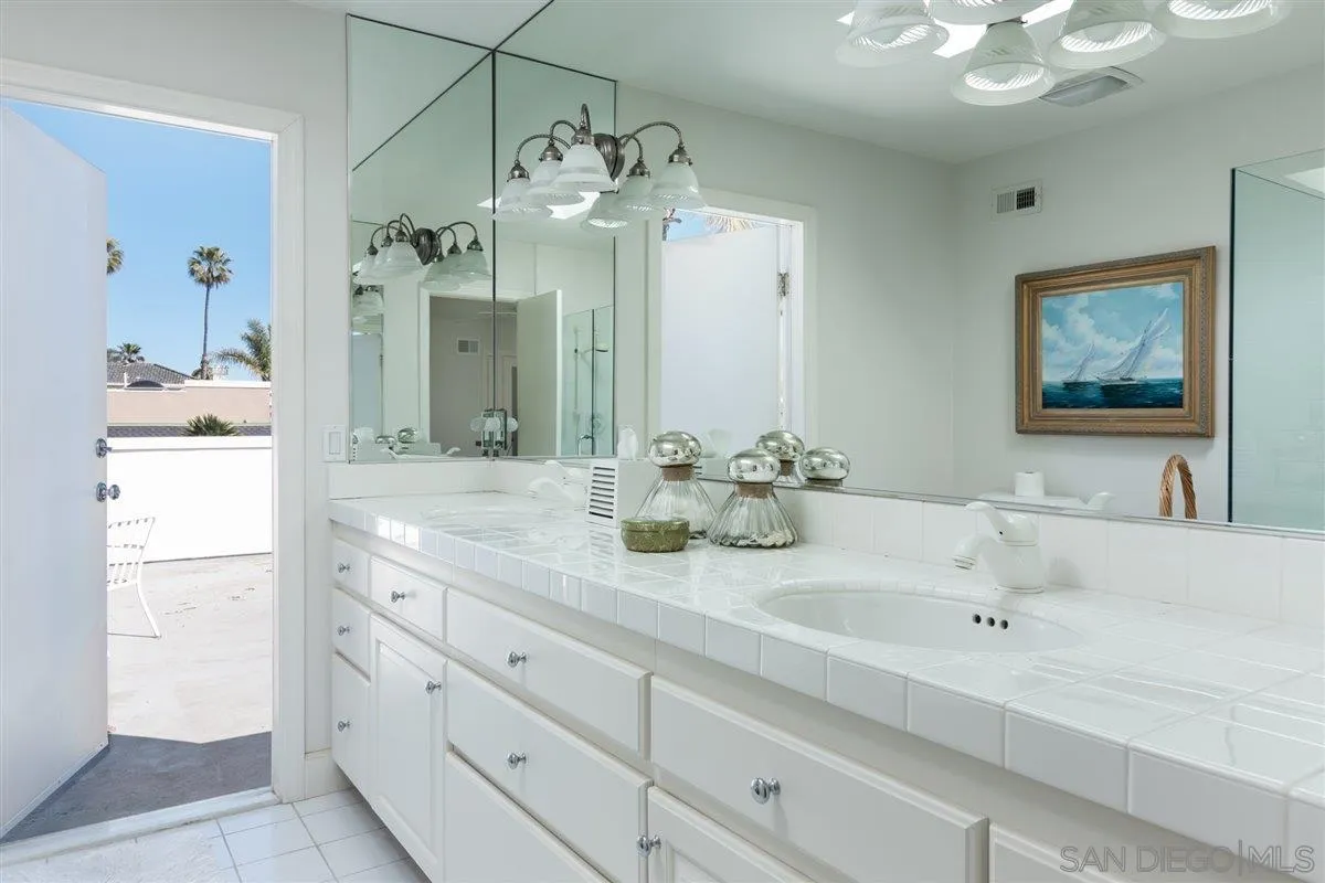 48 Half Moon Bend Coronado, CA 92118 - Photo 33 of 41 a bathroom with a double vanity sink and a mirror