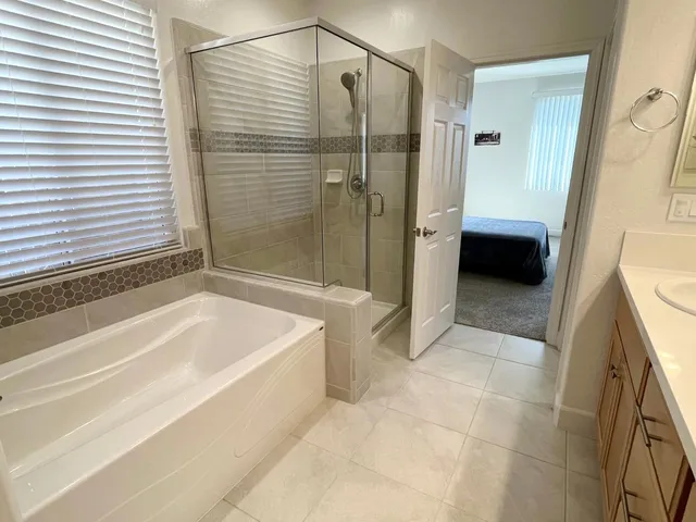 a bathroom with a bathtub and a shower