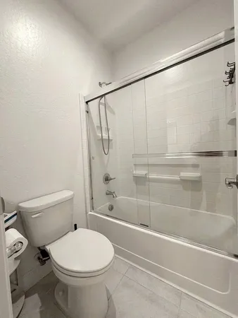 a bathroom with a toilet and a shower