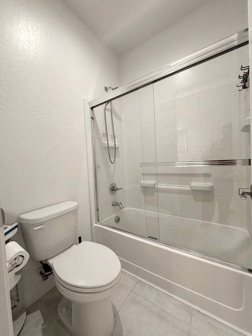 1405 West Tyler Court Visalia, CA 93291 - Photo 16 of 28 a bathroom with a toilet and a shower