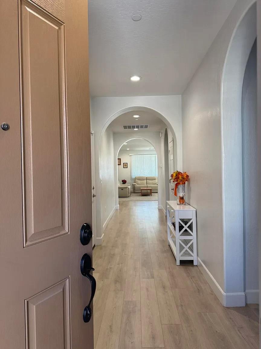 1405 West Tyler Court Visalia, CA 93291 - Photo 2 of 28 a view of a hallway with a living room