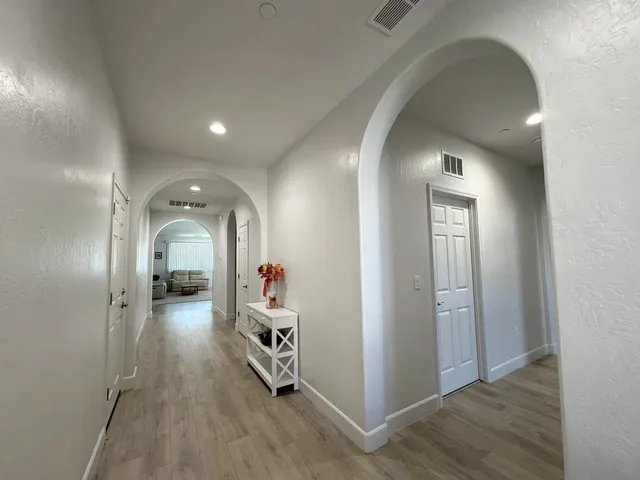 wooden floor with windows and closet in a room
