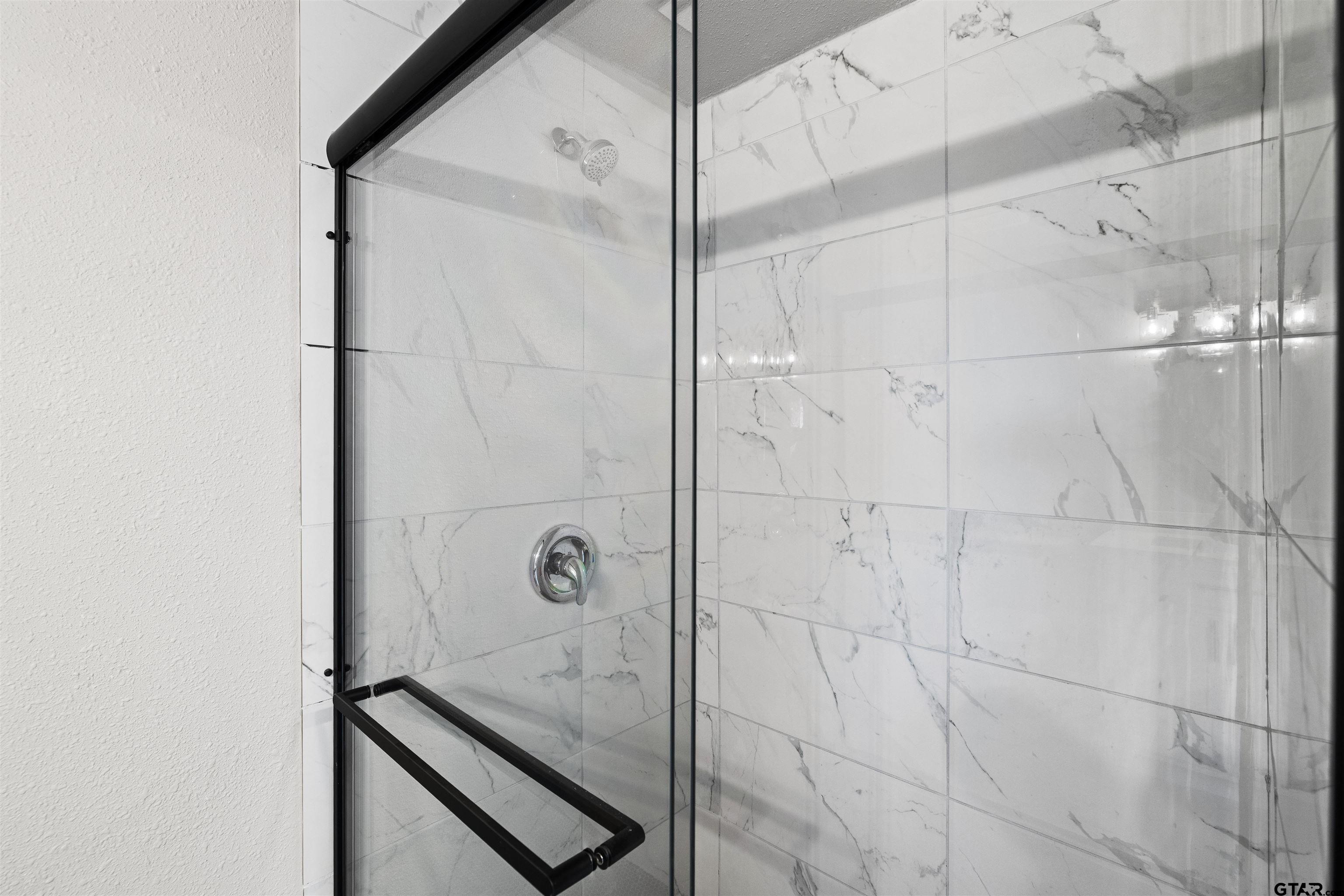 229 Orchard Street Alba, TX 75410 - Photo 13 of 16 a bathroom with a glass shower door