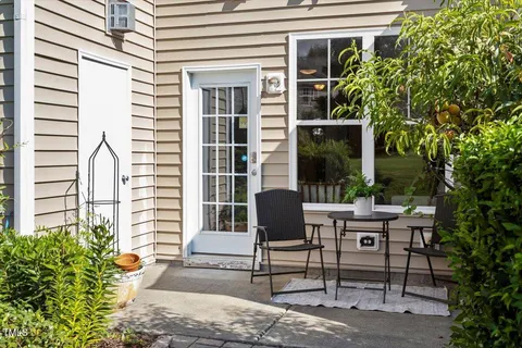 a view of a patio with table and chairs and potted plants