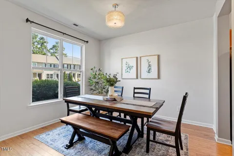 a dining room with furniture a rug and a window