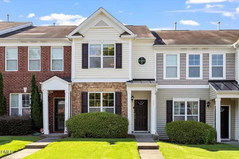 a front view of a house with yard and porch