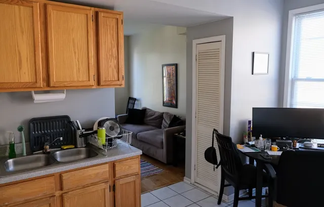 a view of a workspace with furniture and a window