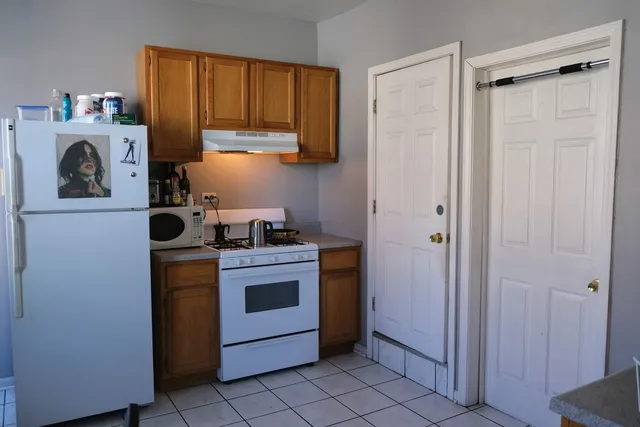 a kitchen with a stove and a refrigerator