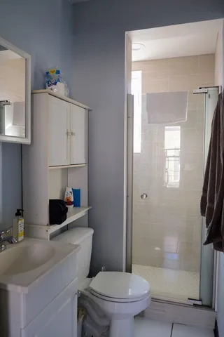 a bathroom with a toilet a sink and a mirror